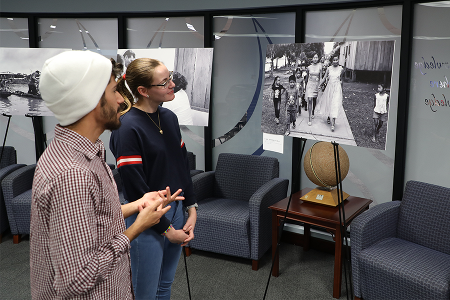 Students at an Amazonia Week photo exhibit
